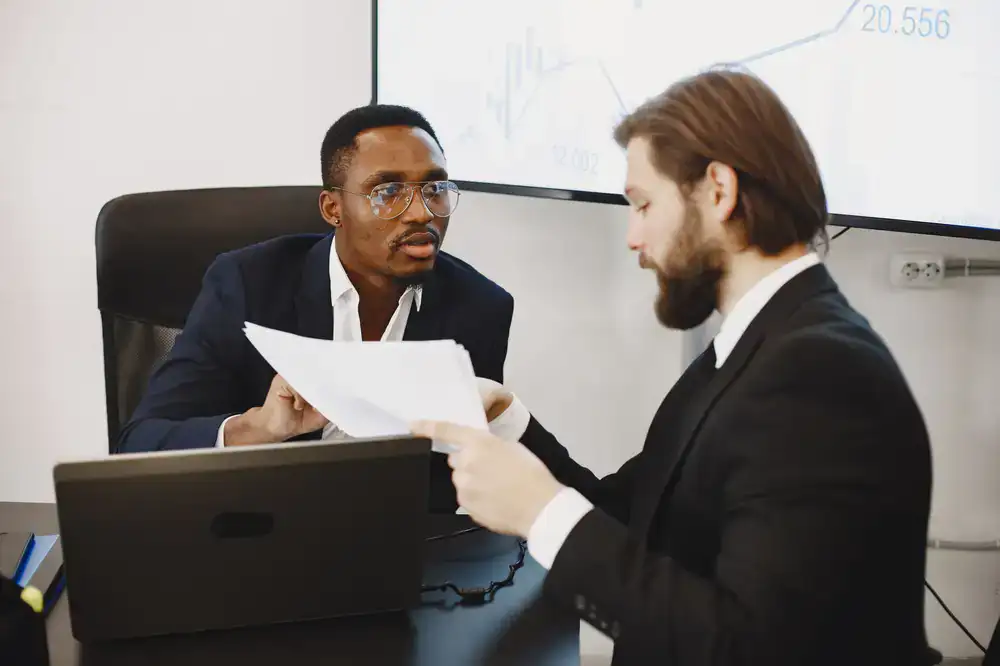 Two professionals discussing a business report