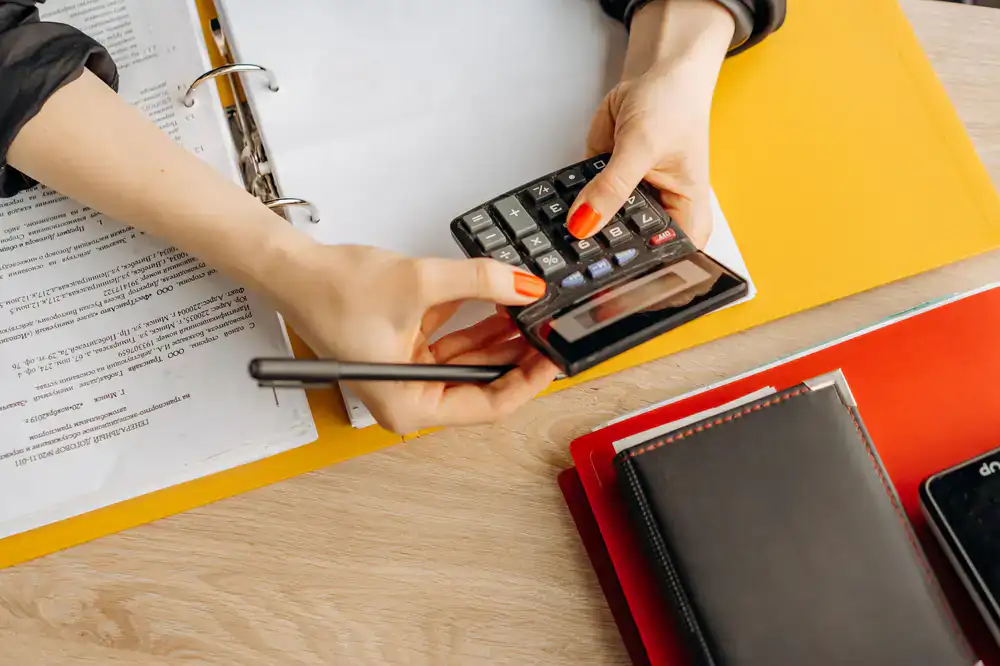 Accountant systematically organizing financial documents on a well-lit desk